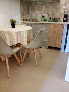 a kitchen with a table with two chairs and a sink at Gaios Rest Apartment Central Gaios Stay Walk Everywhere in Gaios +54 photos