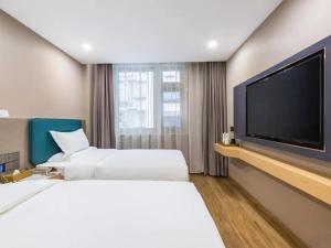 Postel nebo postele na pokoji v ubytování CHEERMAY Hotel Beijing Dongzhimen Guijie Lama Temple
