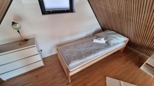 a small bed in a room with a window at Jodłowe Zacisze in Lubkowo