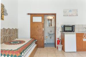 a room with a bed and a bathroom with a sink at Mouria Studio 4 in Kithnos +17 photos