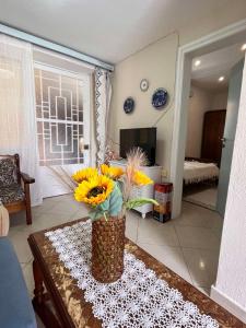 a vase of flowers on a table in a living room at Iliodromi - The Sun Path Retreat in Vourliótai +44 photos