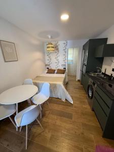 a bedroom with a bed and a table and chairs at Casita Las Palmeras 3 in Cádiz