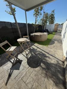 a patio with a table and a chair and an umbrella at Casita Las Palmeras 3 in Cádiz