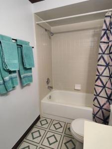 a bathroom with a tub and a toilet and towels at Mandarin I95 2 bedrooms Quiet area Backyard in Jacksonville +27 photos