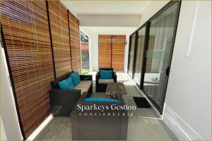 a living room with a couch and a table at SG6 Maison du Moulin - Grand Baie in Grand Baie
