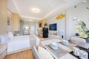 a bedroom and living room with a bed and a table at Madison Urban Stay - Free Massage and Laundry in Hanoi