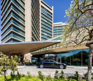 a car parked in a parking lot in front of a building at InterContinental Grand Ankara by IHG in Ankara