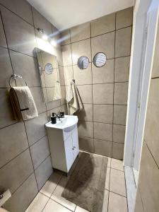 a bathroom with a sink and a mirror at Grey house in Didyma +16 photos