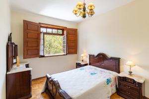 Ένα ή περισσότερα κρεβάτια σε δωμάτιο στο Casa Fermil do Lago