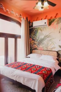a bedroom with a bed and a wall with a mural at 一千零一夜喀什古城民宿 Kashgar Ancient City Scenic Area in Kashgar