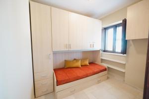 a small bed in a room with a window at TRULLO MALVISCHI - Privacy & Pool in Alberobello