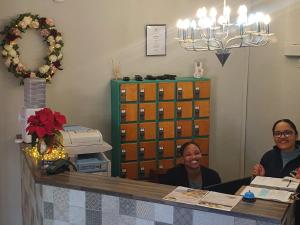 two women sitting at a counter in a room at Point Village Hotel and Self Catering in Mossel Bay