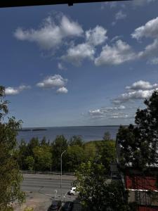a view of a parking lot with a view of the water at RD Apartments - Pispalan Aarre in Tampere +1 photo