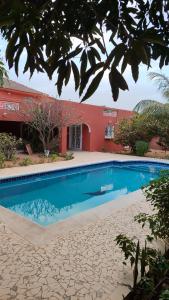 a swimming pool in front of a house at HaciendO in Somone