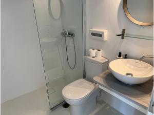 a bathroom with a toilet and a glass shower at La Priva Calma in Agios Ioannis