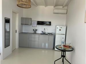 a kitchen with a refrigerator and a table in a room at La Priva Calma in Agios Ioannis +9 photos
