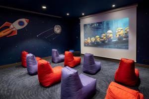 a room with colorful chairs in front of a screen at Liberty Signa in Fethiye