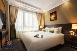 Voodi või voodid majutusasutuse Lotusama Central Hanoi Hotel toas