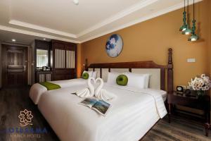 Voodi või voodid majutusasutuse Lotusama Central Hanoi Hotel toas