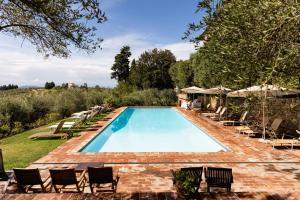 a swimming pool with chairs and umbrellas at Villa Il Poggiale Dimora Storica in San Casciano in Val di Pesa