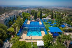 an overhead view of a pool at a resort at pisgat shoresh in Shoresh