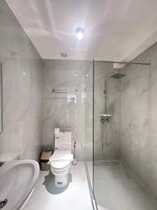 a bathroom with a shower and a toilet and a sink at North Star Hotel in Yakkasaray +118 photos