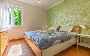 Ένα ή περισσότερα κρεβάτια σε δωμάτιο στο Apartments Pimpinella