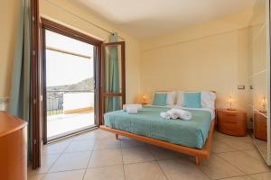 a bedroom with a bed and a large window at A Casa di Sofi in Marco Simone