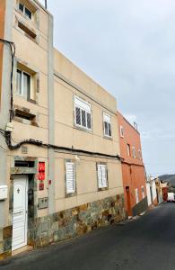 a building on the side of a street at Flat with jacuzzi in suite in Agüimes