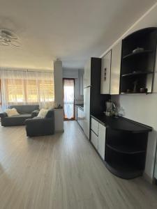 a living room with a couch and a kitchen at Casa Vacanze 228 in Villa Rosa +29 photos