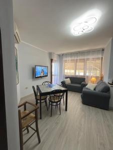 a living room with a table and a couch at Casa Vacanze 228 in Villa Rosa