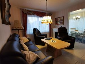 a living room with a couch and a table at Ferienhaus Mooi Huus 95157 in Rhauderfehn