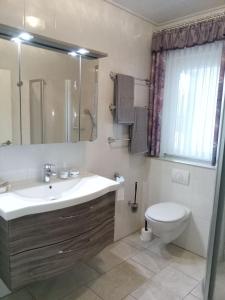 a bathroom with a sink and a toilet at Ferienhaus Mooi Huus 95157 in Rhauderfehn