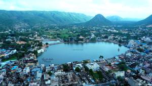 an aerial view of a city with a large body of water at Hotel Ajanta in Pushkar