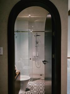 a bathroom with a shower with a toilet and a sink at Thom Homestay in Da Lat +61 photos