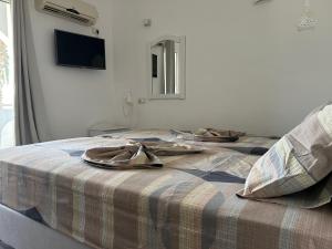 two beds with shoes on top of them in a room at Garden Villa in Karpathos +15 photos