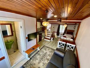 a living room with a couch and a tv in a tiny house at Ephesus Selcuk Castle View Suites in Selçuk