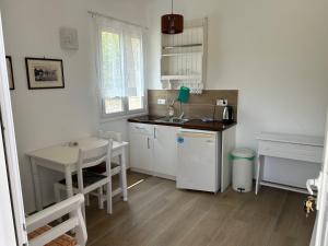 a small kitchen with a table and a sink at Garden Villa in Karpathos