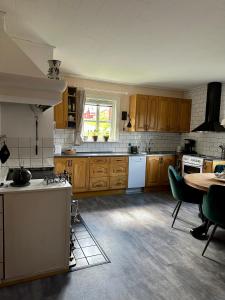a kitchen with wooden cabinets and a table in it at B&B Knuss in Öje +11 photos