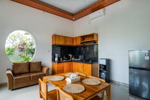 a living room with a table and a kitchen at Obah Villa Ubud 1 Br Brand new private villa in Ubud