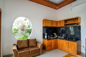 a living room with a chair and a mirror at Obah Villa Ubud 1 Br Brand new private villa in Ubud