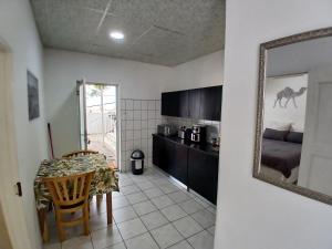 a kitchen with a table and a mirror at Villa Saffier in Windhoek