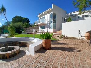 a house with a fire pit in the yard at Villa Saffier in Windhoek