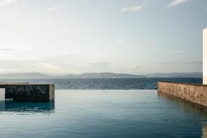 a swimming pool with a view of the water at Horizon Luxury Seafront Villa in Vaia