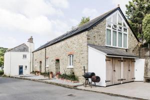 an old brick building with a garage at The Millbrook Inn in Kingsbridge