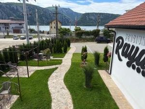a walkway next to a building with mountains in the background at Pensiunea Raya in Dubova