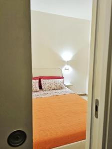 a small bedroom with a bed in a room at Ariel Apartment Ortigia Siracusa in Siracusa