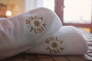 a close up of a white towel with the words just at Willa Tusia in Międzyzdroje
