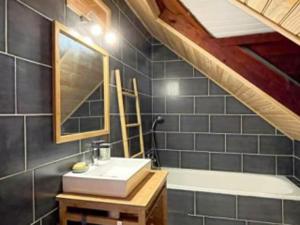 a bathroom with a sink and a bath tub at Villa Kaz K vue sur la mer des Caraibes in Bouillante +25 photos