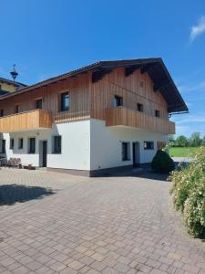a building with a wooden roof and a brick driveway at Appartement am Moserhof in Stein an der Enns